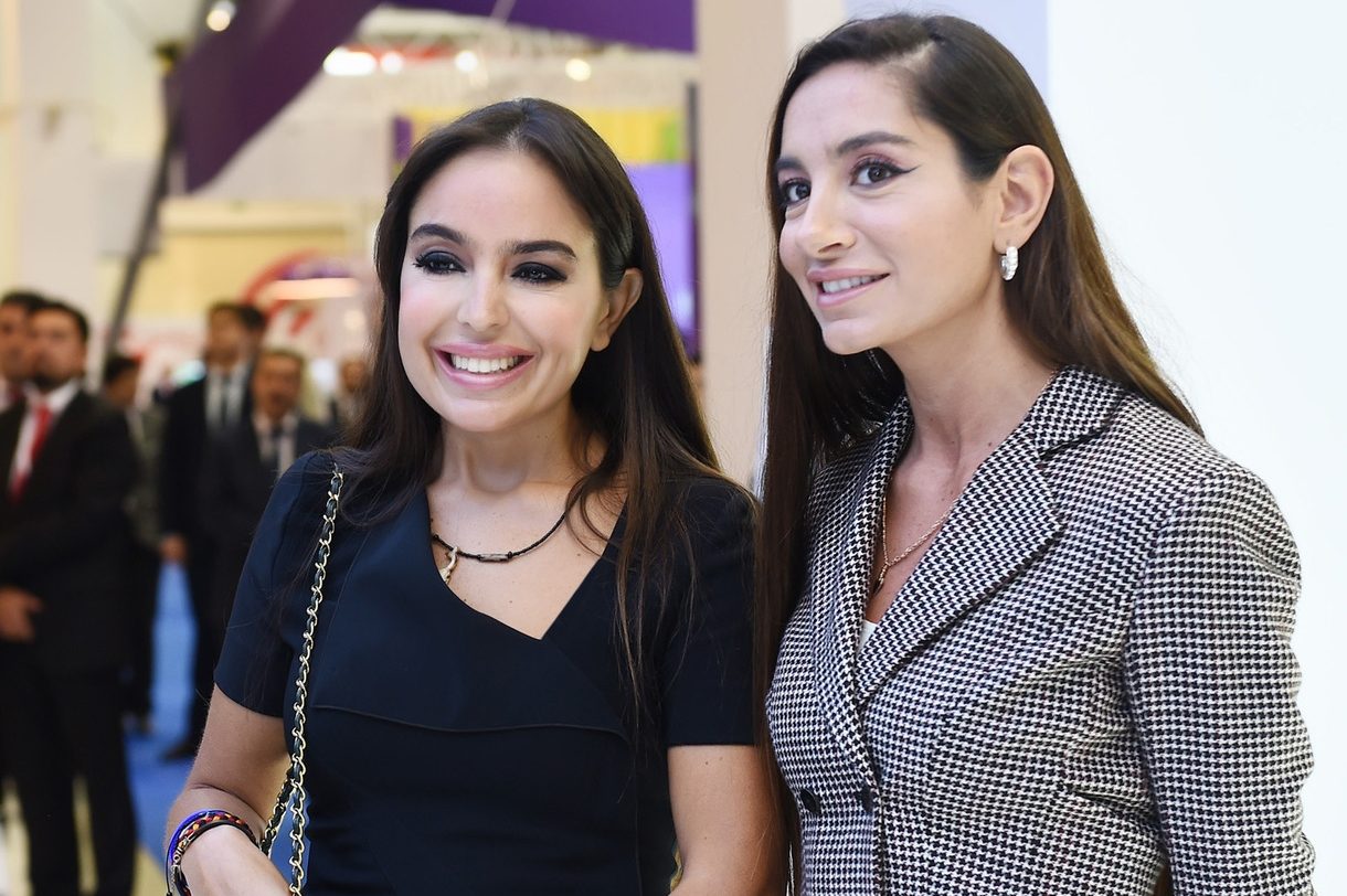 Leyla and Arzu Aliyeva smiling at the camera at an event