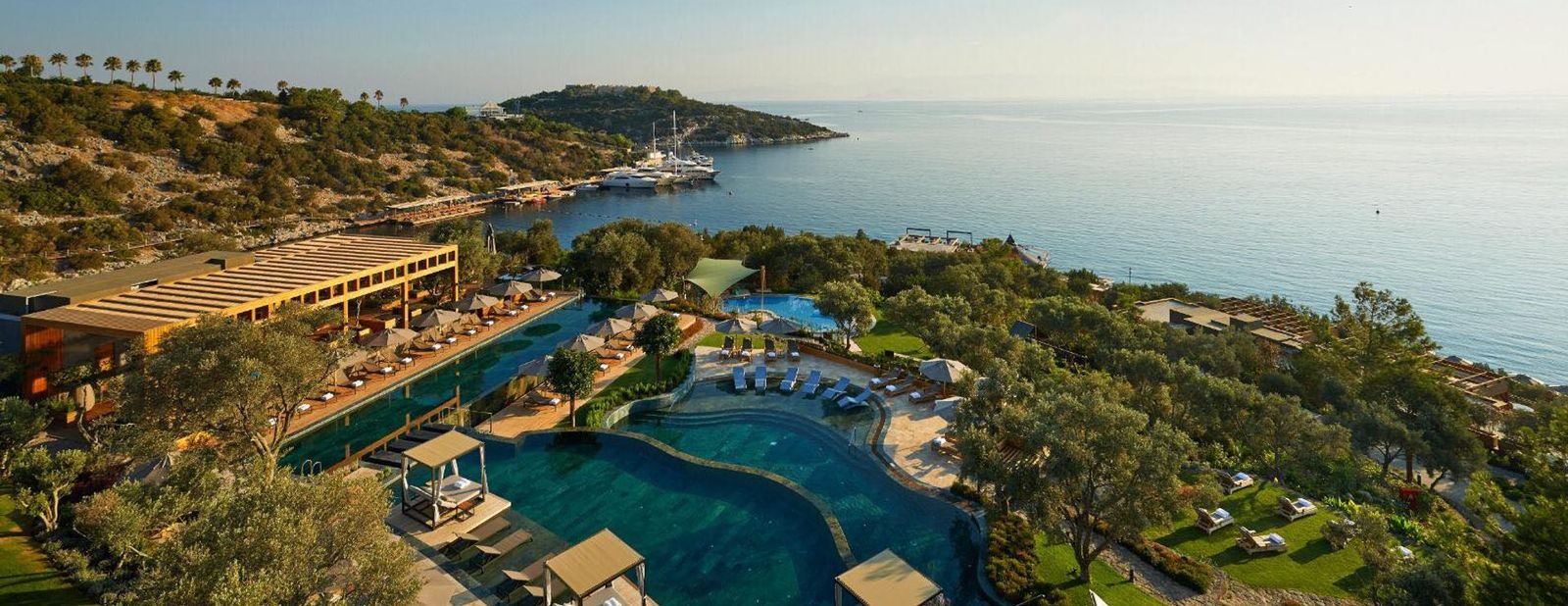 Aerial view of Mandarin Oriental Bodrum, showing the bay, pool and yacht