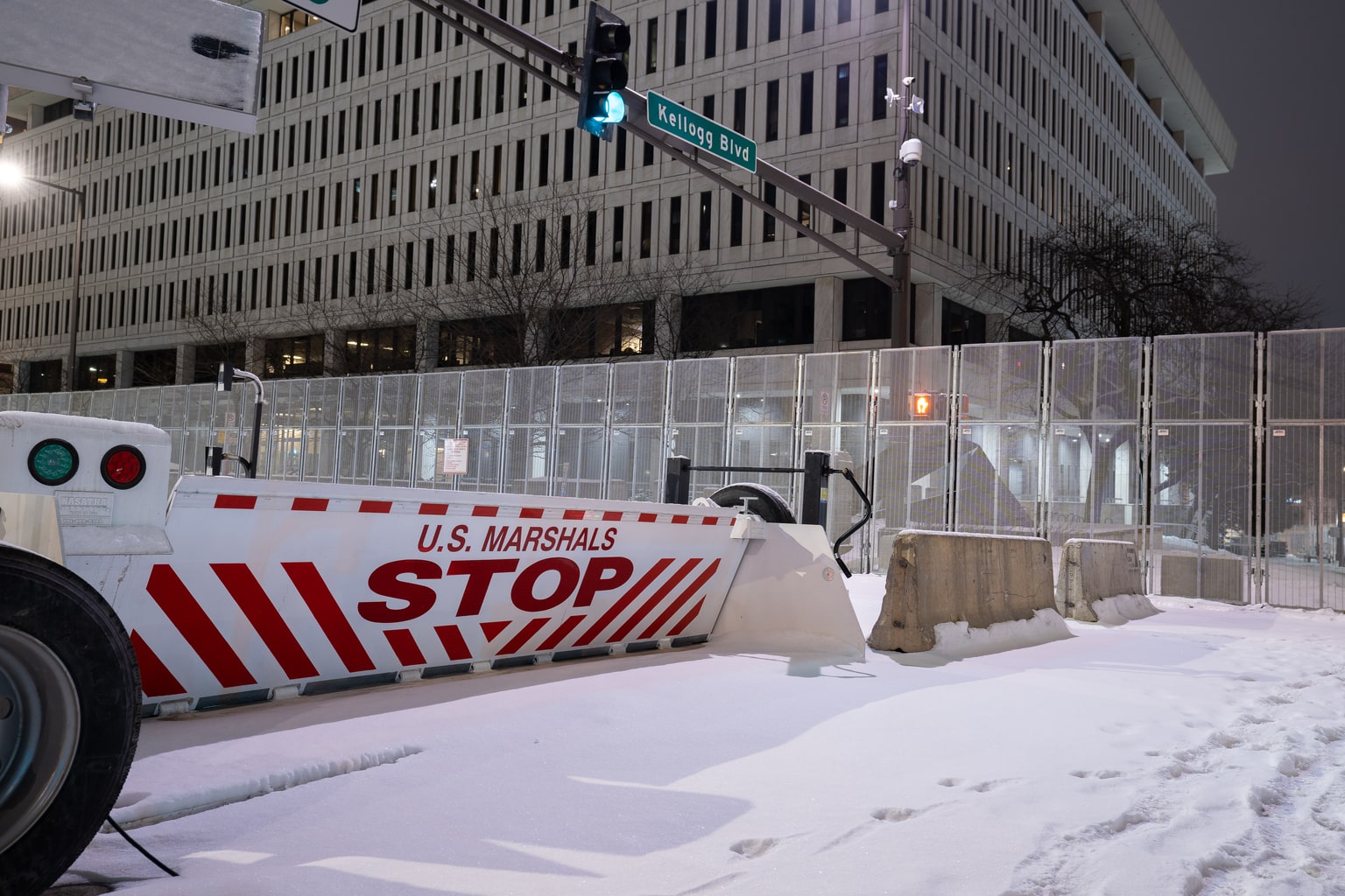 Nighttime exterior of the St. Paul federal courthouse with a U.S. Marshals barrier, January 2022.