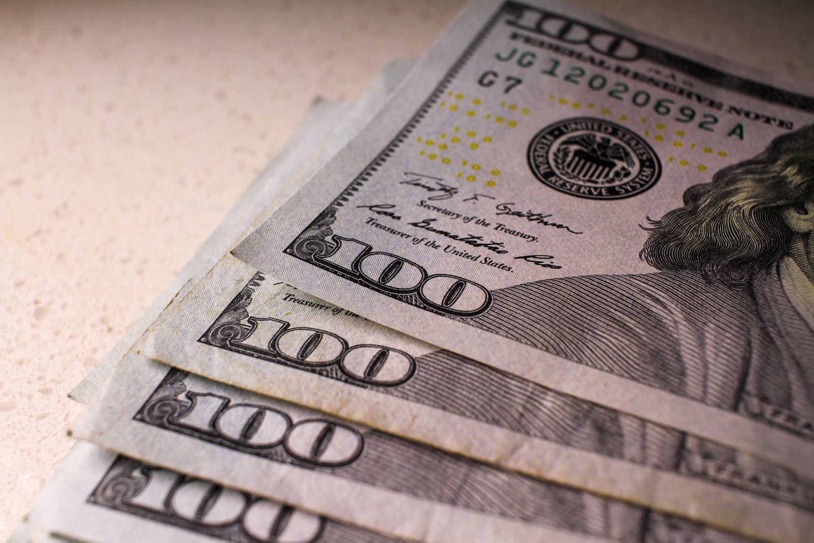 US $100 banknotes, photographed on 30 January 2021. Illustrative archive photograph; the cash shown is not connected to the Zhao case.